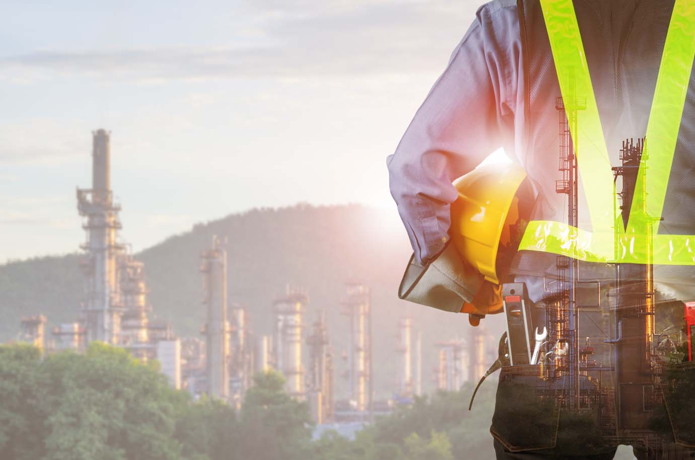Engineer behind with overload tool Double exposure of engineer behind with overload tool holding yellow helmet for safety of the workers, Blurred Oil refinery background.
